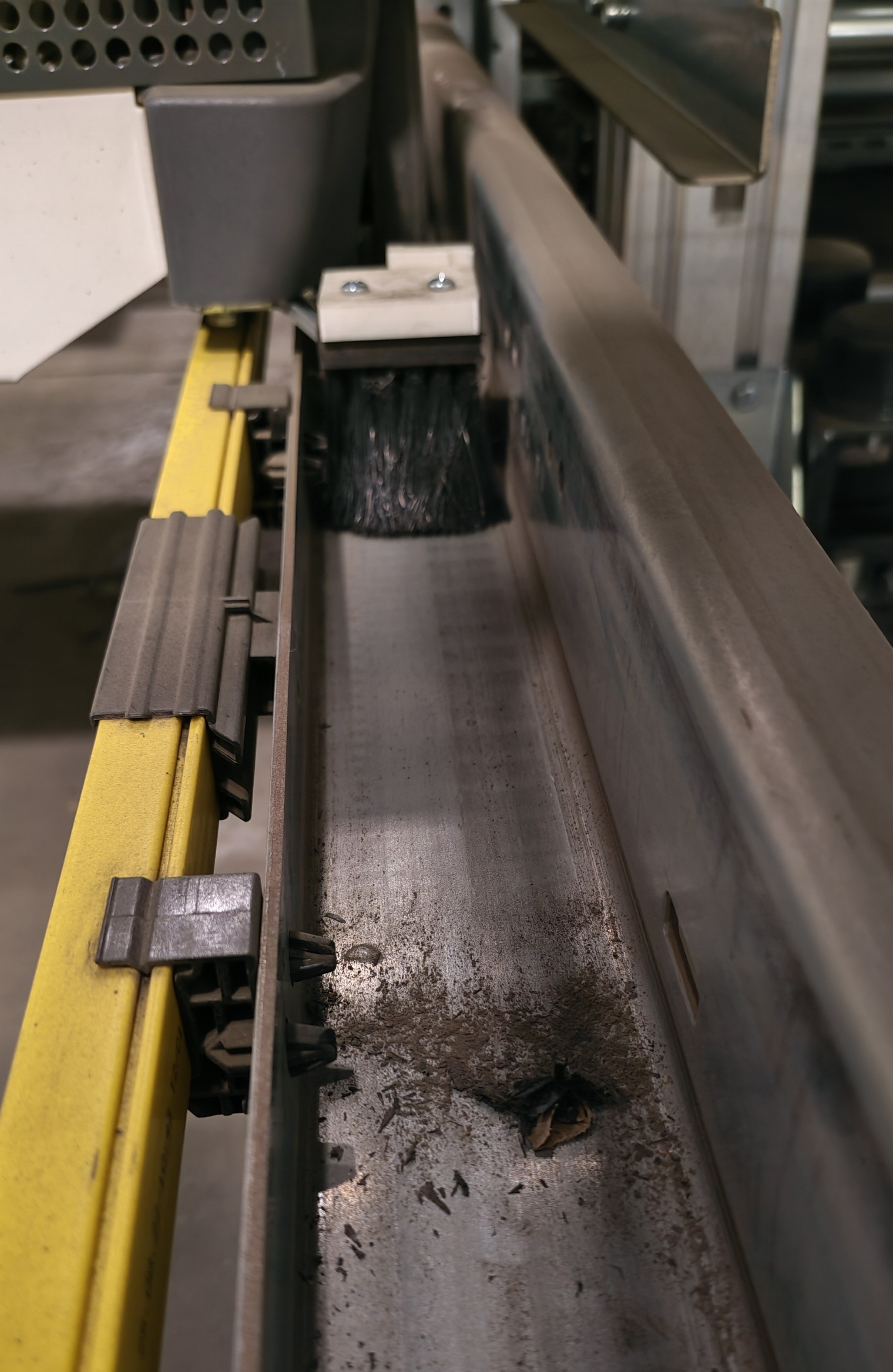 Brush holder installed on shuttle showing brush in wheel trough